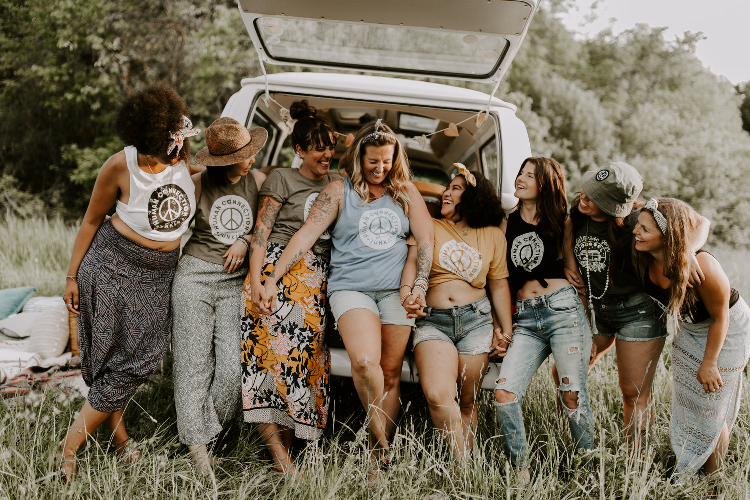 Heather and a group of people in front of the blueberry moon van with human connection junkie racerbacks